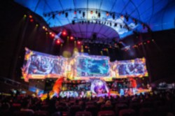 Blurred background of esports event at big arena with a lot of lights and screens