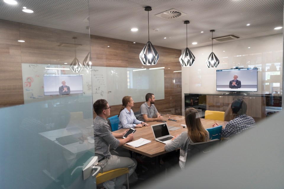 start up business people group attending videoconference call with senior investitior at modern office