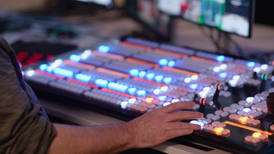 Detail of a broadcast professional managing live transmission of NHL event.