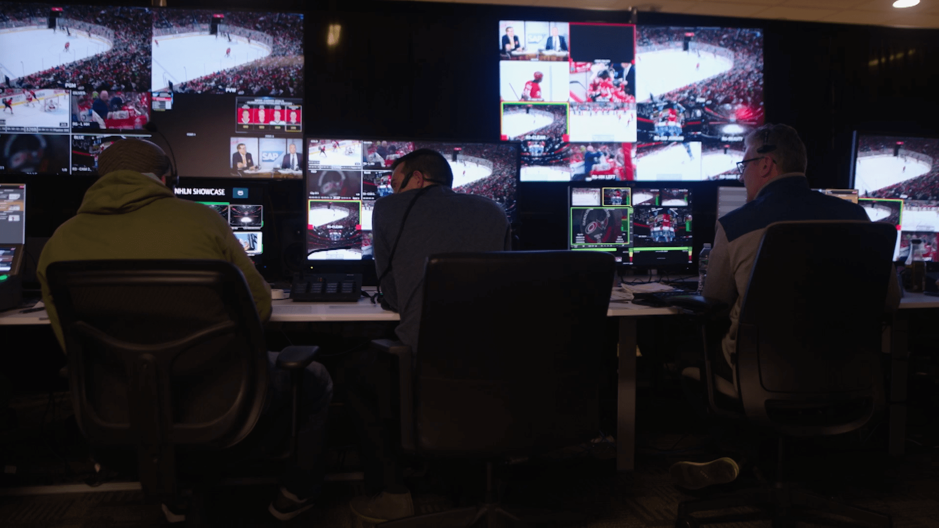 Team of broadcast professionals managing live transmission of NHL event.