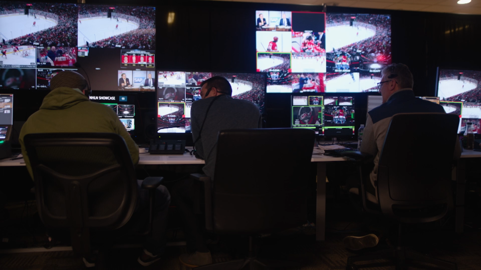 Team of broadcast professionals managing live transmission of NHL event.