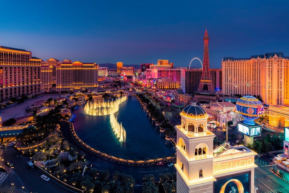 LAS VEGAS, USA - CIRCA JANUARY 2021 : High angle view of fountain show and Las Vegas skyline in Nevada at sunset, USA