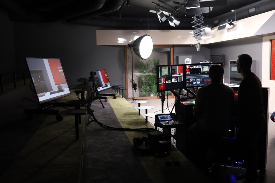 A broadcast studio hums with quiet intensity during a live production